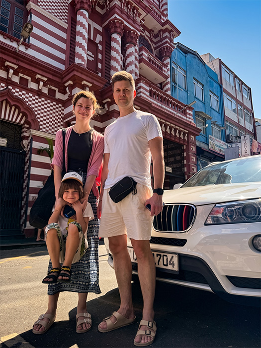 Family of three posing infront of a mosque in Colombo